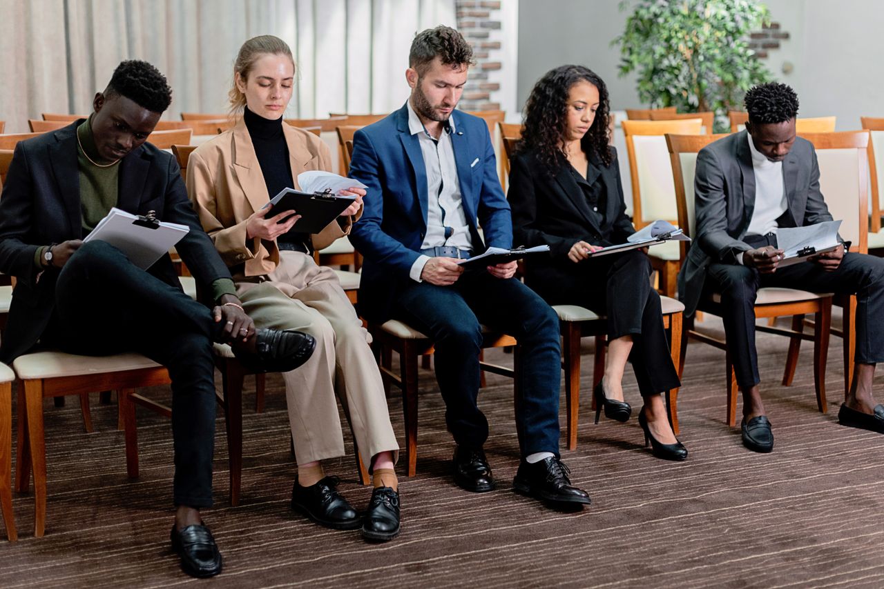 Home A diverse group of business professionals reviewing documents in a meeting setting.